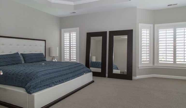 White shutters in a minimalist bedroom in Fort Myers.